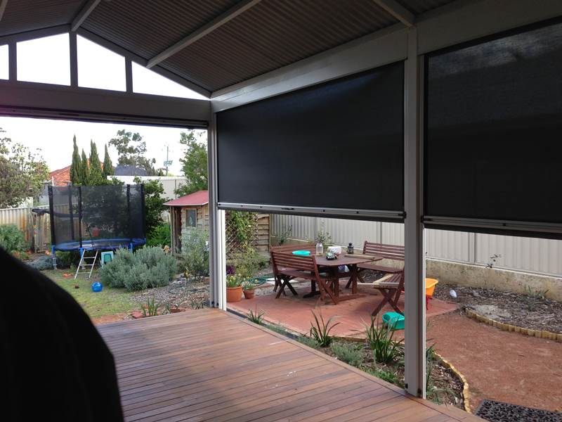 looking out from verandah with dark mesh outdoor blinds.